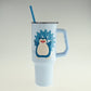 Light blue tumbler with a cartoon penguin design on a light gray background