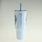 Light blue tumbler with a straw on a white background