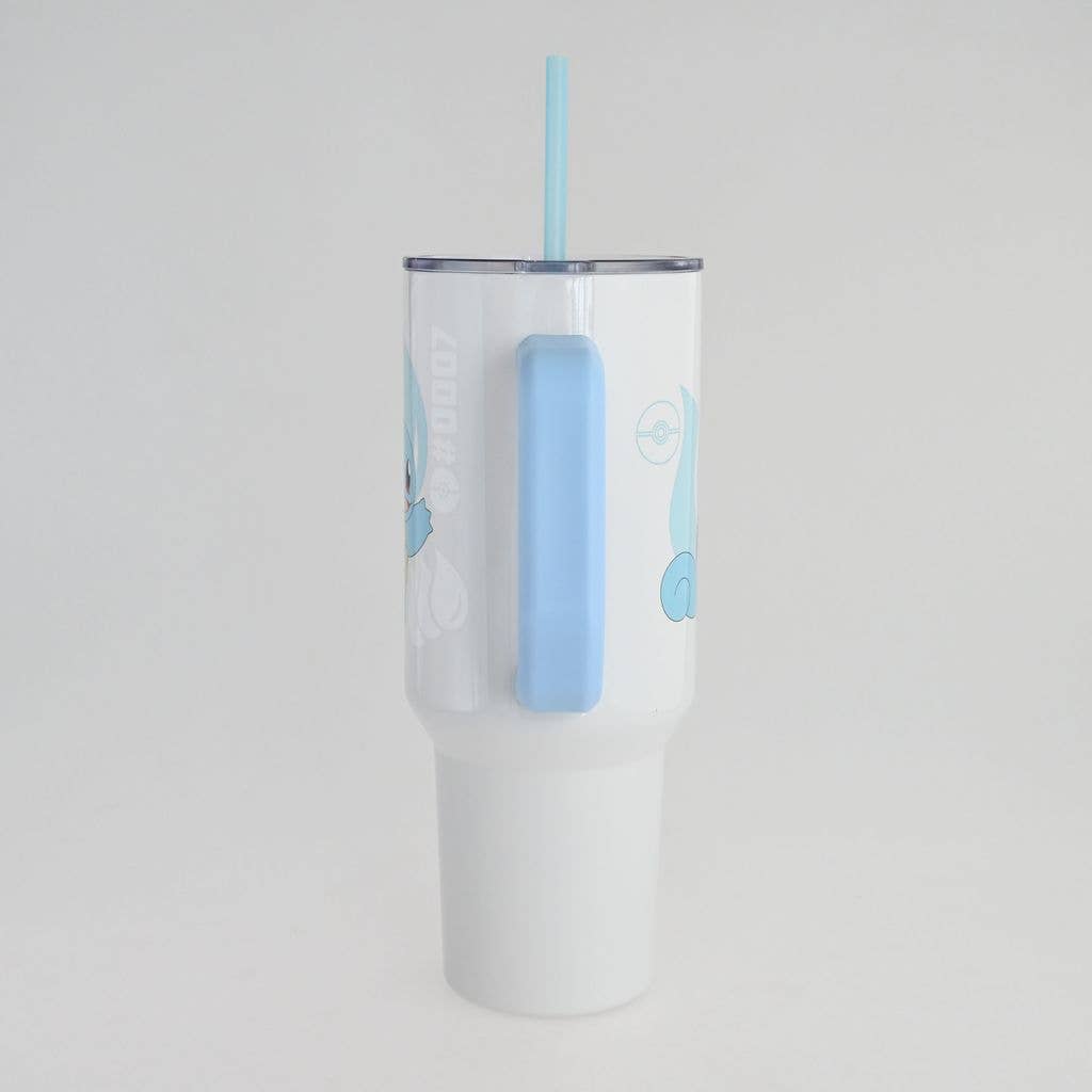 Clear tumbler with blue handle and straw on a light gray background