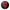 Circular design with a red and black face on a black background