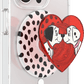 Phone case with heart design featuring a character and polka dots on a clear background