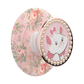 A round decorative accessory with a pink floral pattern on one side and a circular face featuring Marie the white cat character surrounded by faux pearls and a rose-gold border on the other. A white mounting stem is visible in the center.