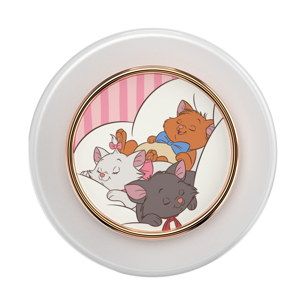 A round white cosmetic compact or container with a gold-toned inner rim and a colorful illustration of three sleeping cats on the front. The cats are in a pink-striped room, with one orange cat wearing a blue bow tie and one dark gray cat wearing a red bow tie.