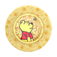 Circular decorative item with a cartoon character and bee patterns on a yellow background