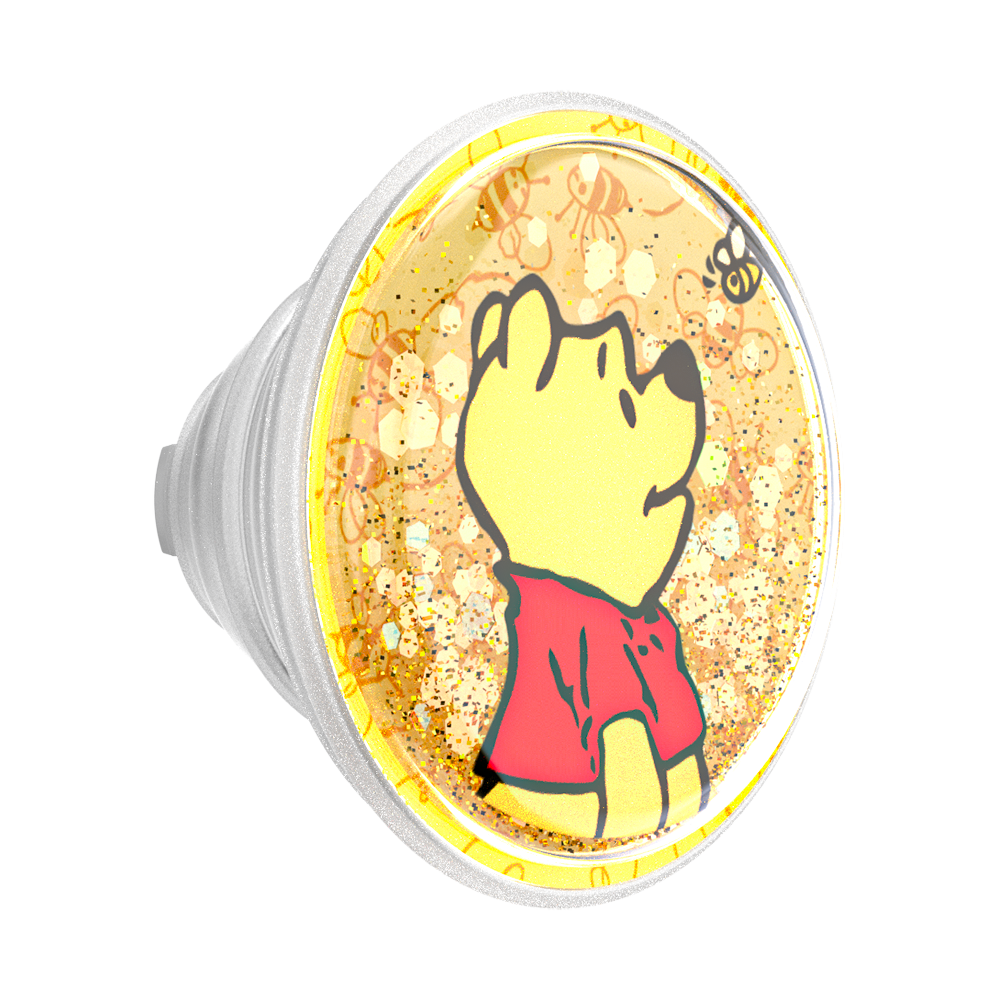 A round clear plastic cup or tumbler with a printed Winnie the Pooh design, featuring a yellow bear in a red shirt on a glittery gold background, with a white screw-on base visible on the left.