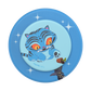 A circular blue phone grip or coaster featuring a cartoon illustration of a blue tiger cat with orange eyes and a small witch hat, on a white background.