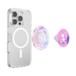 A clear protective phone case with a MagSafe ring, shown alongside two interchangeable pop-swap grips: one with a pink and purple abstract wave pattern and one featuring a cartoon girl illustration on a pink background.