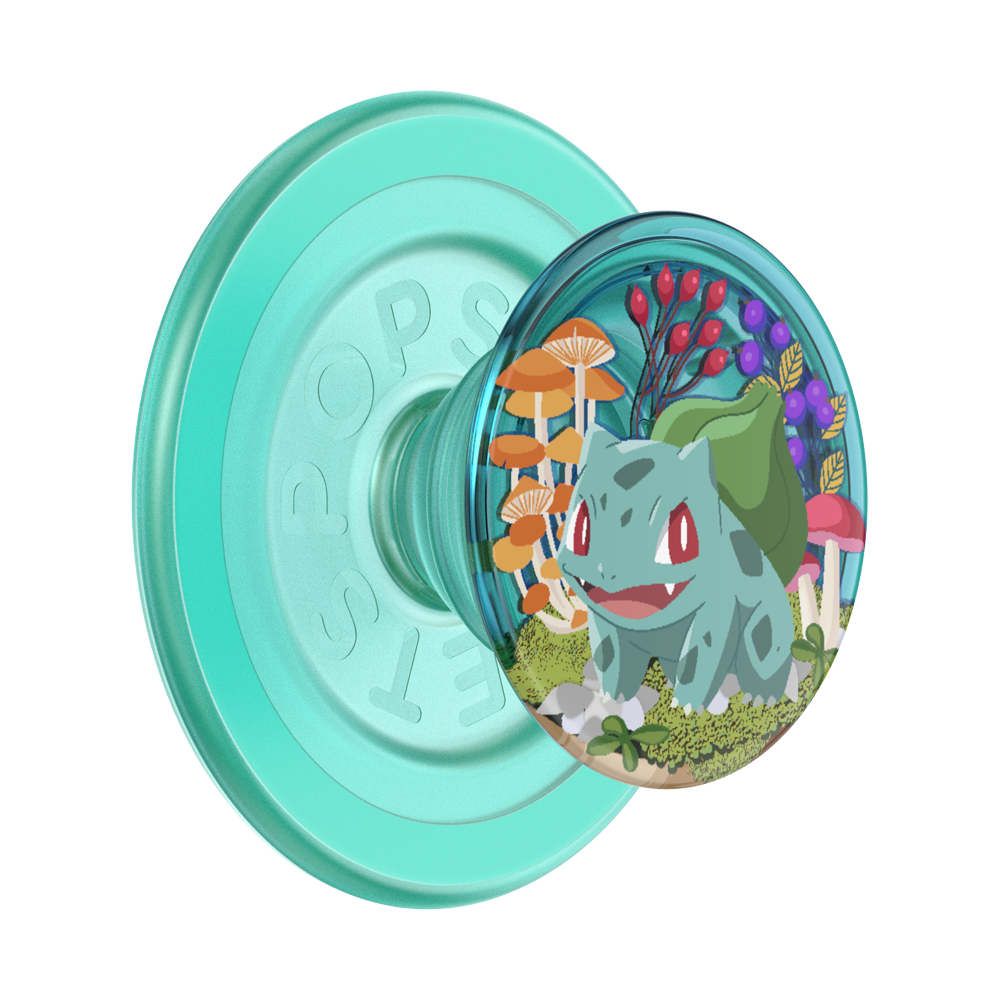 A translucent mint green PopSockets phone grip featuring a circular clear window with an illustration of Bulbasaur surrounded by colorful mushrooms and foliage, shown on a plain white background.