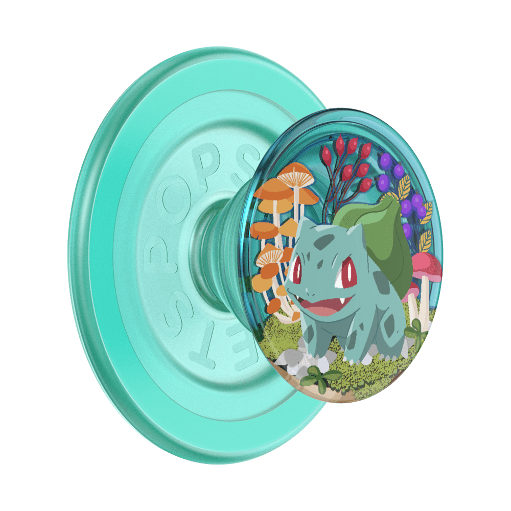 A translucent mint green PopSockets phone grip featuring a circular clear window with an illustration of Bulbasaur surrounded by colorful mushrooms and foliage, shown on a plain white background.