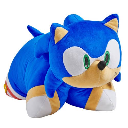 Blue plush toy with a white face and red, yellow, and blue stripes on its feet against a white background