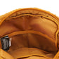 Close-up of a mustard yellow bag with a mesh pocket and a tag inside.