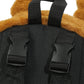 Close-up of a black backpack with brown fur trim on a white background