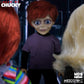 Toy figure with red hair and purple shirt in a dark setting, surrounded by other figures.