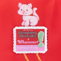 Strawberry Shortcake crossbody bag styled as a collectible accessory inspired by 1980s doll artwork
