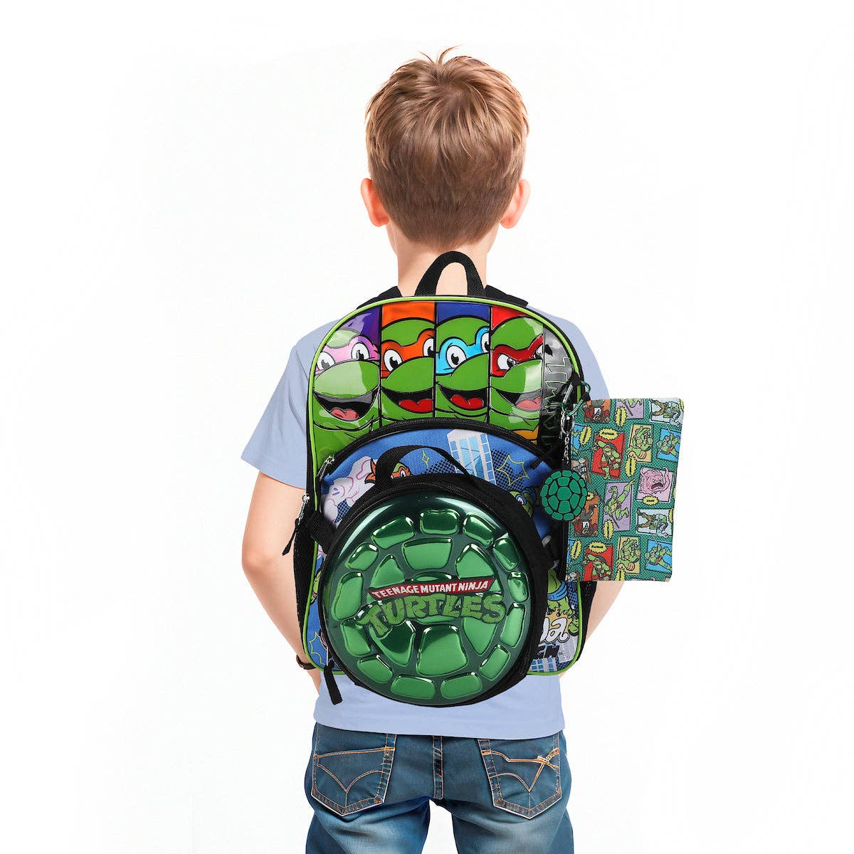 Child wearing a Teenage Mutant Ninja Turtles backpack on a white background