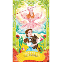 Illustration of a character in a pink dress with a wand, Dorothy in a blue dress holding a dog, and a green border with flowers.