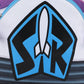 Close-up of a white backpack featuring a large black and blue graphic with a white rocket ship in the center and the letters 'SR' inside a shield-like shape.