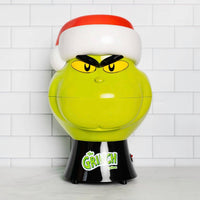 Grinch-themed gumball machine with a white tiled background