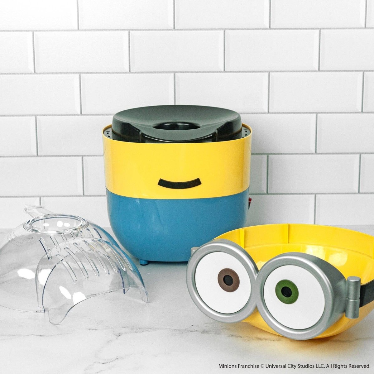 Minion-themed kitchen appliance on a white tiled wall background