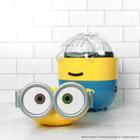 Minion-themed popcorn maker on a white tiled background