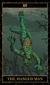 Tarot card featuring a green figure hanging by its wrists with a dark background.