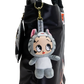 A Betty Boop plush keychain character hanging from a black bag. The plush toy is styled as a cat in a gray and white outfit with pink inner ears, large cartoon-style eyes, and a Betty Boop branded tag attached.