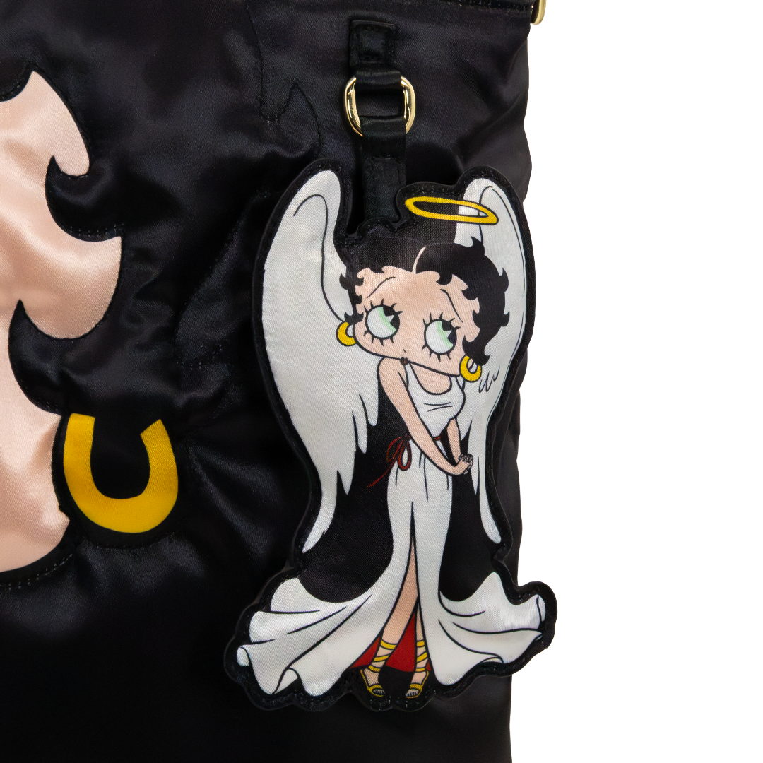 A close-up of a black satin garment featuring a large embroidered angel-shaped patch with Betty Boop's face, white wings, a gold halo, and red and yellow shoes.