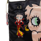 Close-up of a black satin handbag featuring a large Betty Boop face graphic and a hanging Betty Boop character charm in a red and yellow dress.