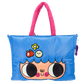 Blue tote bag with cartoon face design and pink handle on a white background
