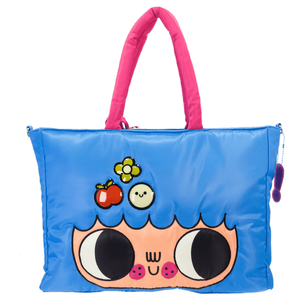 Blue tote bag with cartoon face design and pink handle on a white background