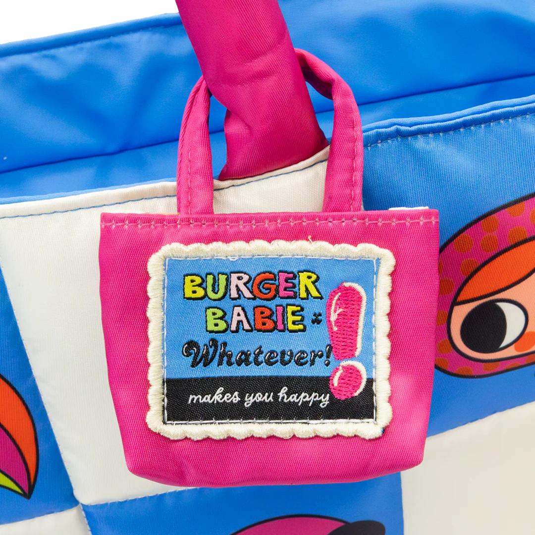 Small pink bag with 'Burger Baby' label held by a hand against a blue background