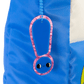 Blue backpack with a pink character-shaped zipper pull on a white background