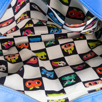 Close-up of a colorful patterned fabric with checkered design and cartoonish faces on a blue background.