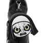 A black nylon shoulder bag featuring a round front zipper pocket with a white fabric patch shaped like a cartoon skull face with yellow eyes and black stitched details, attached to a silver metal clasp.