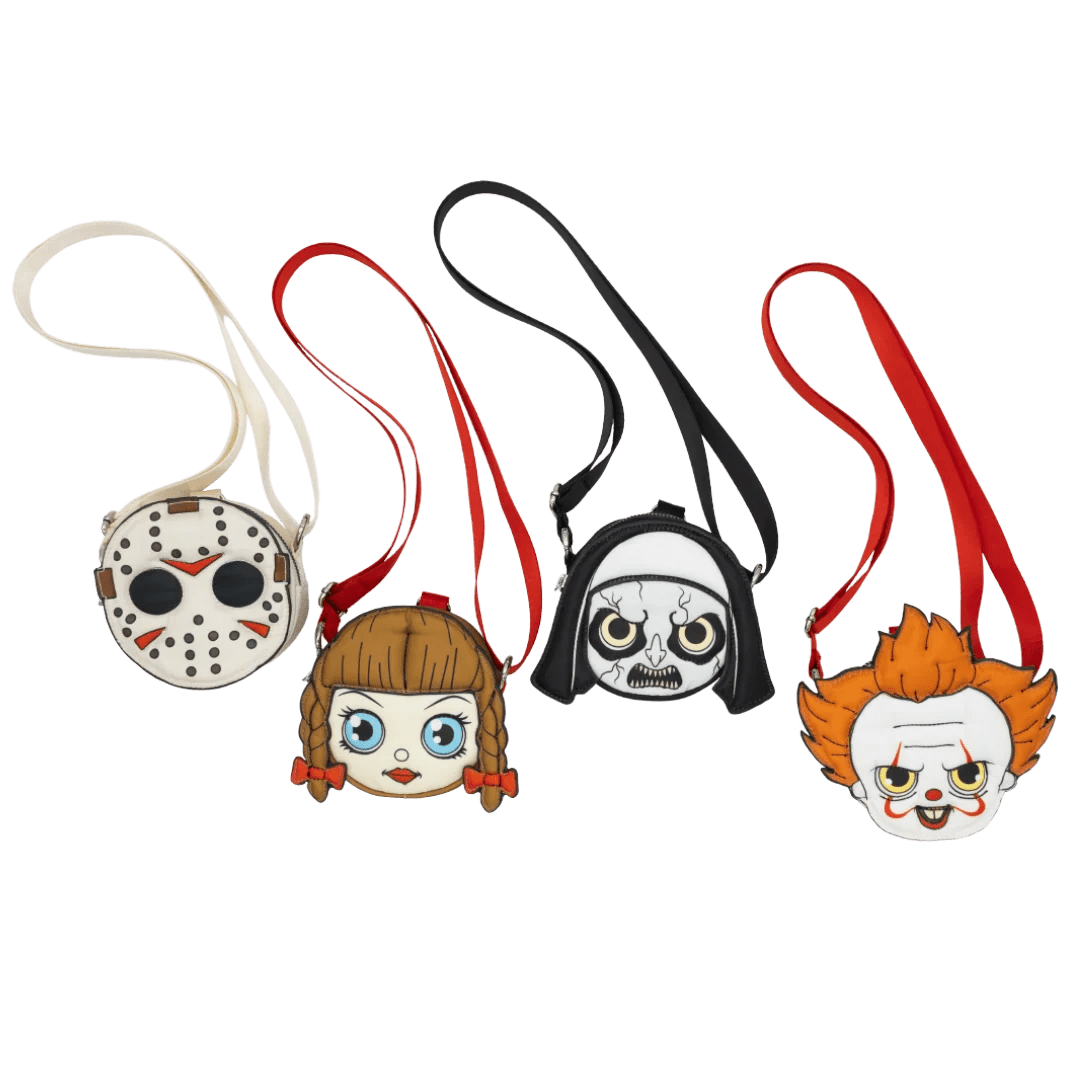 Four small crossbody-style pouches shaped like horror character faces, arranged side by side on a plain white background. The designs resemble Jason Voorhees, a girl with pigtails, Darth Vader, and Pennywise the Clown, each with a long strap and a small front pouch.