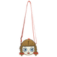 A small shoulder bag shaped like a cartoon girl's face, featuring brown hair in braids, large blue eyes, and red accents, with a long red strap on a plain white background.