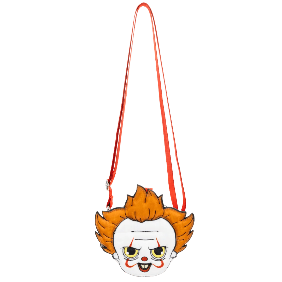 A small crossbody bag featuring a cartoon clown face with orange hair, a white face, and red makeup details, suspended from a red strap against a plain white background.