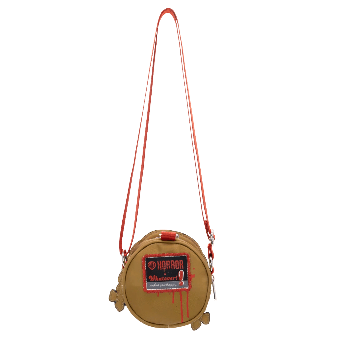 A small round tan crossbody bag with a bright red strap and a red front patch reading 'HORROR' and 'Whatever', shown on a plain white background.