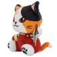 A plush toy cat character with black, orange, and white fur, wearing red overalls and holding a knife, photographed on a plain white background.