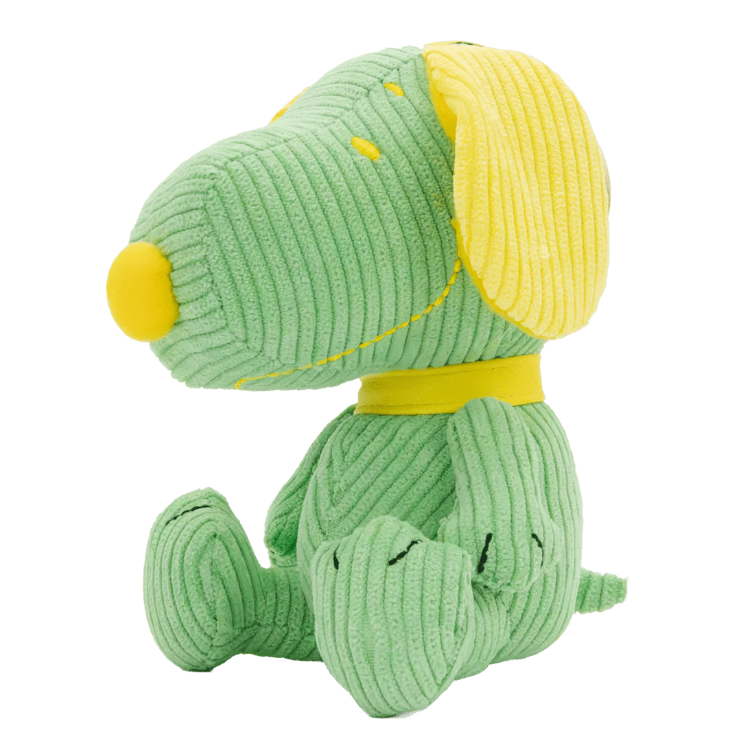 Green plush dog toy with yellow accents on a white background