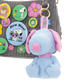 Blue dog-shaped keychain with pink collar on a gray surface with colorful buttons.