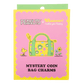 Packaged mystery coin bag charms with a cartoon design on a pink background