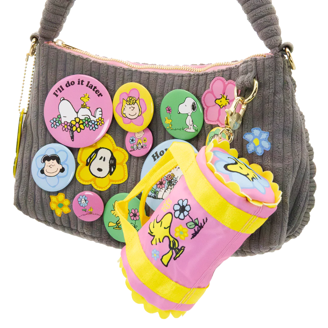 Gray handbag with colorful buttons and a pink rain boot keychain on a white background