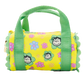 Yellow duffel bag with green handles and floral patterns on a white background