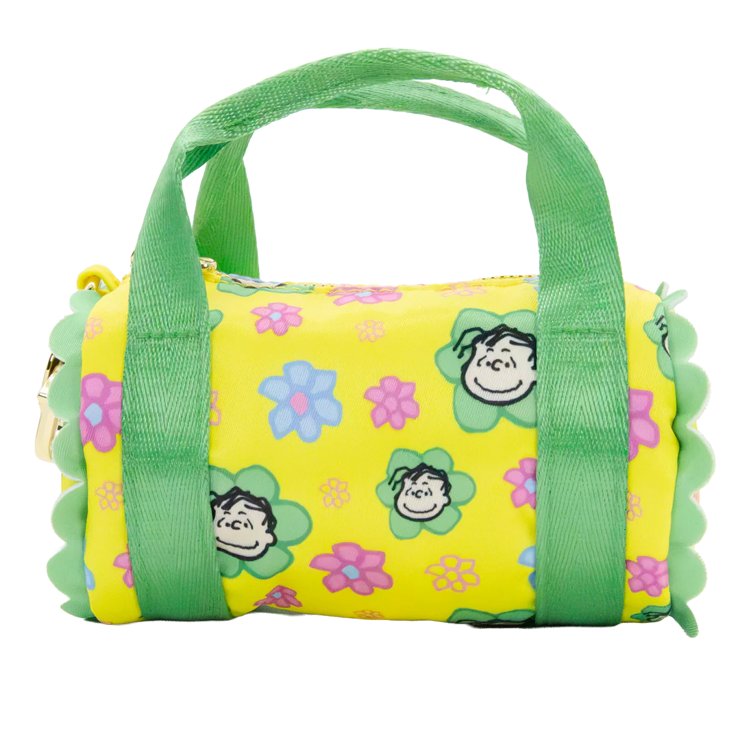 Yellow duffel bag with green handles and floral patterns on a white background