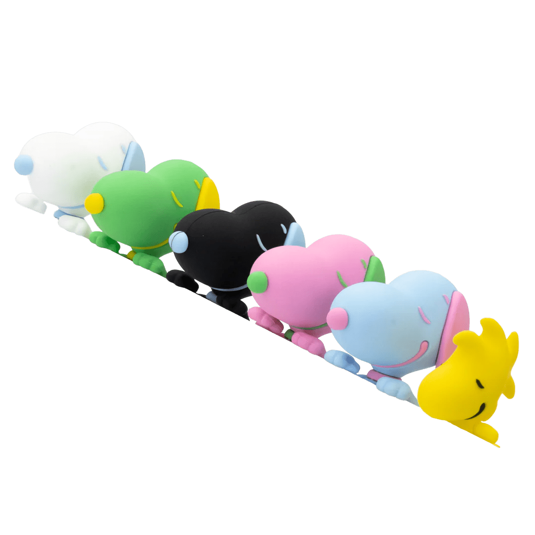 Colorful plush toys arranged in a row on a white background
