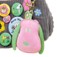 Collection of colorful cartoon buttons and a pink and green character keychain on a textured surface.