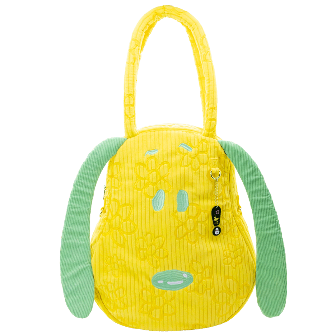 Yellow textured bag with green ears on a white background