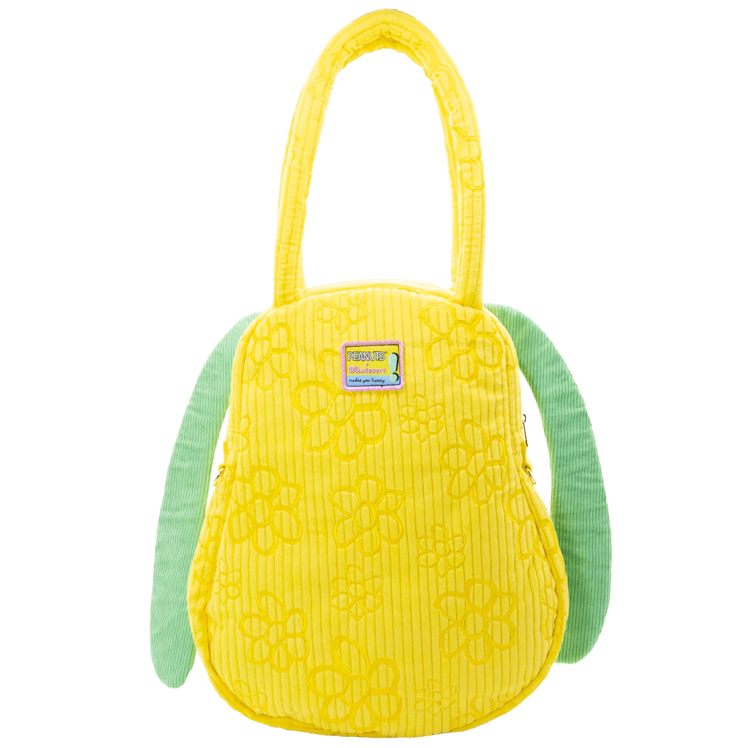 Yellow textured bag with green handles on a white background
