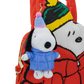 A red Snoopy backpack featuring a plush Snoopy keychain in a blue winter jacket and striped beanie, with a large printed Snoopy face on the back.